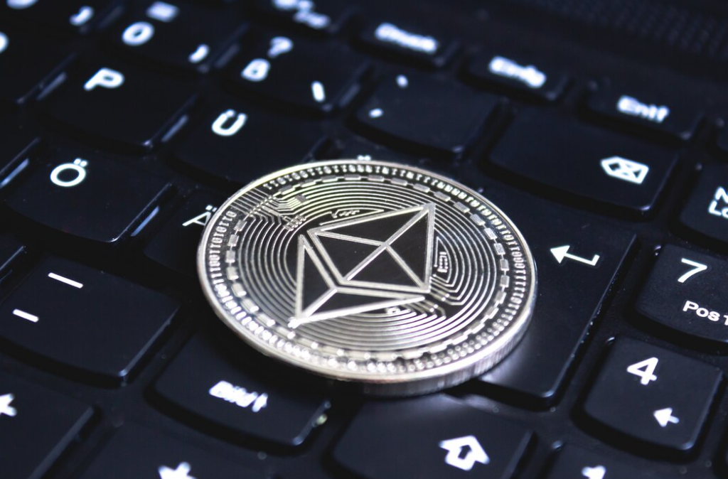 Large coin placed on top of a black computer keyboard